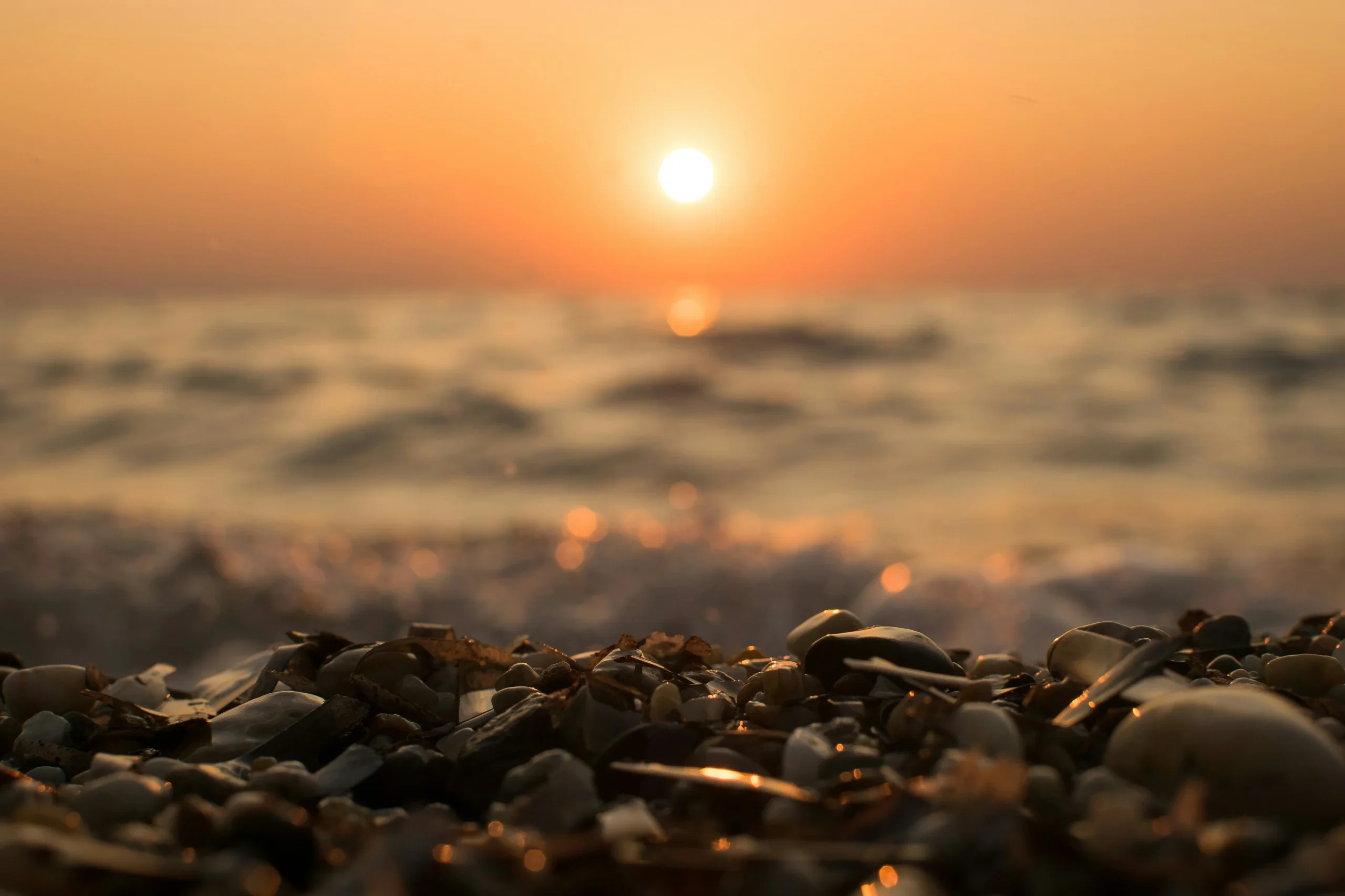 Calming sunset over water symbolising emotional reflection and wellbeing.